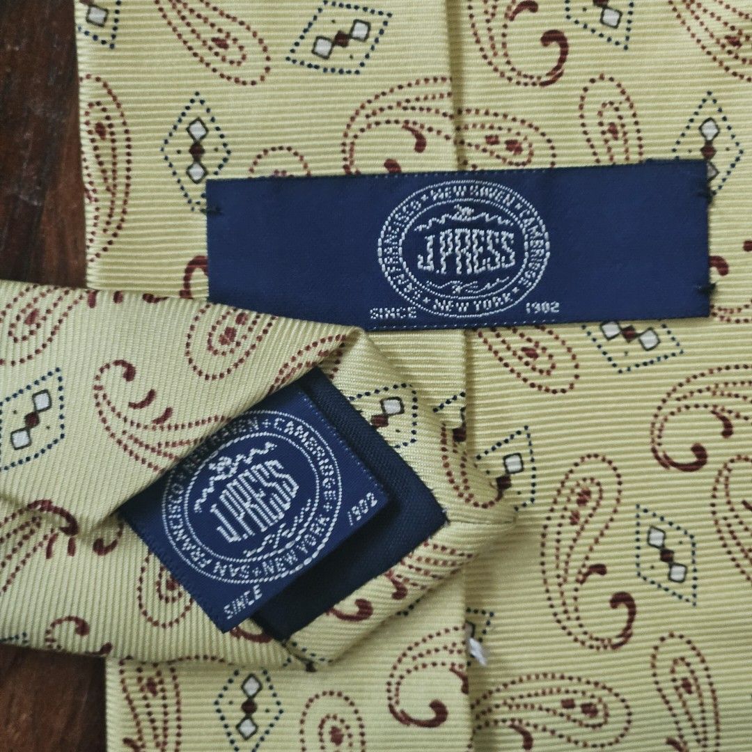 J. Press Yellow Paisley Silk Tie (Category: Ties) located in San Juan City. Submitted by thetropicaltweed (Listing ID 1327641231, Image 2). Description: Condition: Minor creasing from storage, no visible signs of damage and little to no signs of wear. Measurement: Tie width at widest part: 8.5cm Brand Info J. Press has been an iconic brand of the classic American Ivy style and has had a lasting impact in Men's style and Menswear for a better part