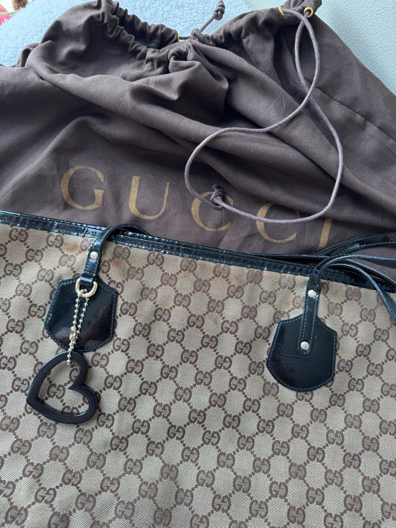 Gucci Tote Bag (Category: Luxury Bags & Wallets) located in Quezon City. Submitted by sunday_thrifts (Listing ID 1357675497, Image 3). Description: Original Gucci Tote Bag With Charm and dustbag Heavily used signs of wear and tear Bought in Singapore.