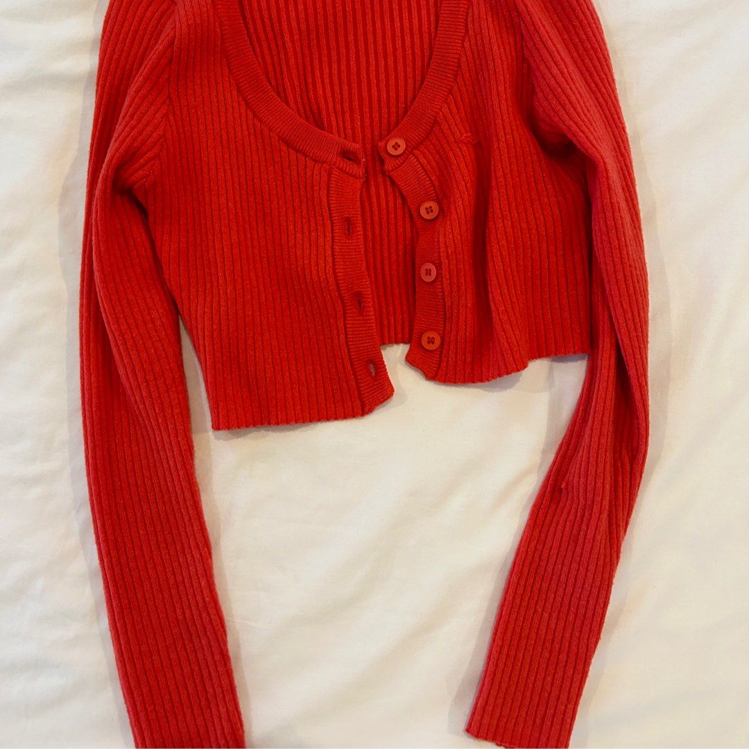 Red cropped cardigan (Category: Longsleeves) located in Muntinlupa City. Submitted by lcvefool (Listing ID 1358075066, Image 2). Description: [CURRENTLY ABROAD] • only worn once! • a few loose threads, but can be cut off! • fitted, fits xs-s DM for inquiries Shipping: GGX/GRAB/LALAMOVE MOP: Gcash only this is second hand, so please manage your expectations!.