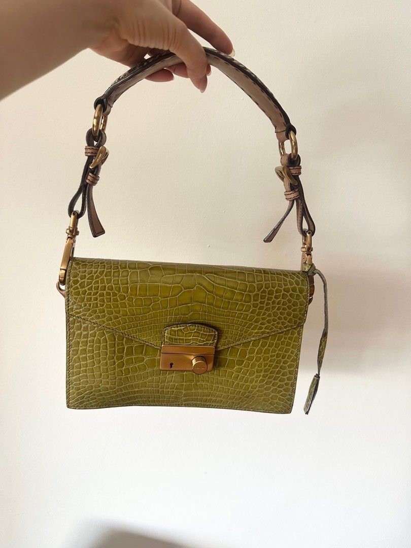 Prada alligator shoulder bag (Category: Bags & Wallets) located in Singapore. Submitted by lovingtheh (Listing ID 1358229270, Image 2). Description: Luxurious shoulder bag in green alligator leather Tan leather straps with houndstooth fabric on top Strap length is adjustable Inside has 2 compartments and side pockets Inside is lined in matching green leather Tiny mark on the front of the bag and scratches on the underside of the shoulder strap 24