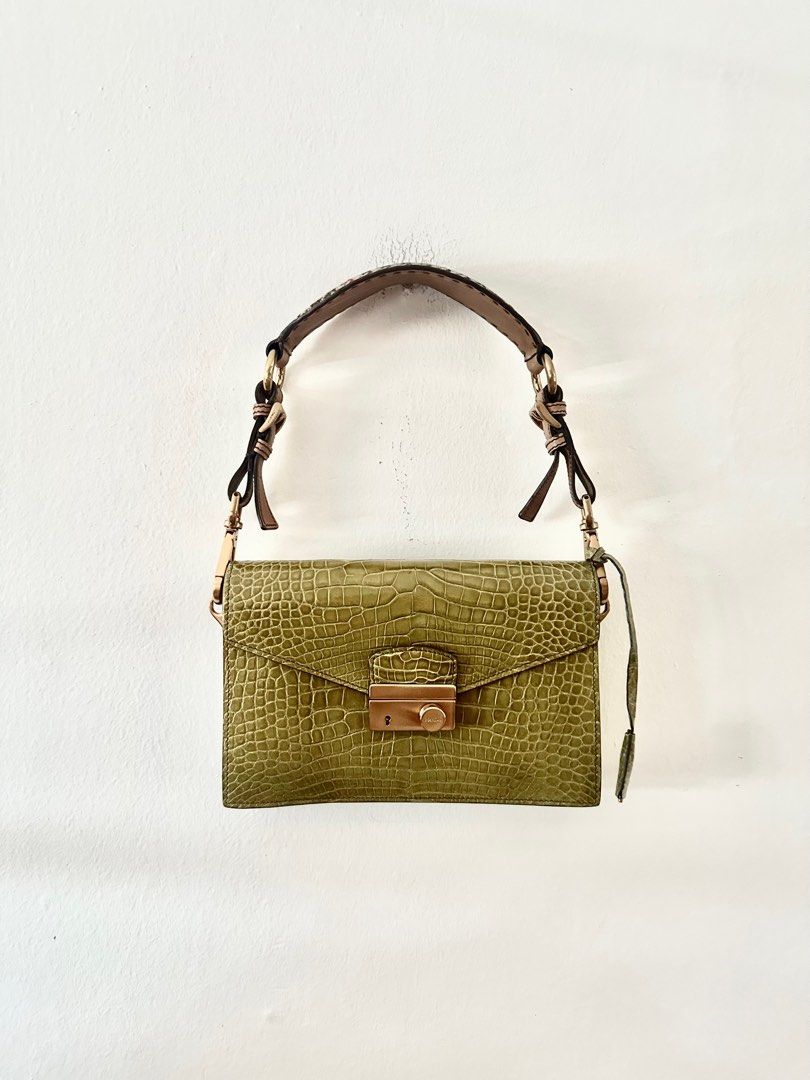 Prada alligator shoulder bag (Category: Bags & Wallets) located in Singapore. Submitted by lovingtheh (Listing ID 1358229270, Image 1). Description: Luxurious shoulder bag in green alligator leather Tan leather straps with houndstooth fabric on top Strap length is adjustable Inside has 2 compartments and side pockets Inside is lined in matching green leather Tiny mark on the front of the bag and scratches on the underside of the shoulder strap 24