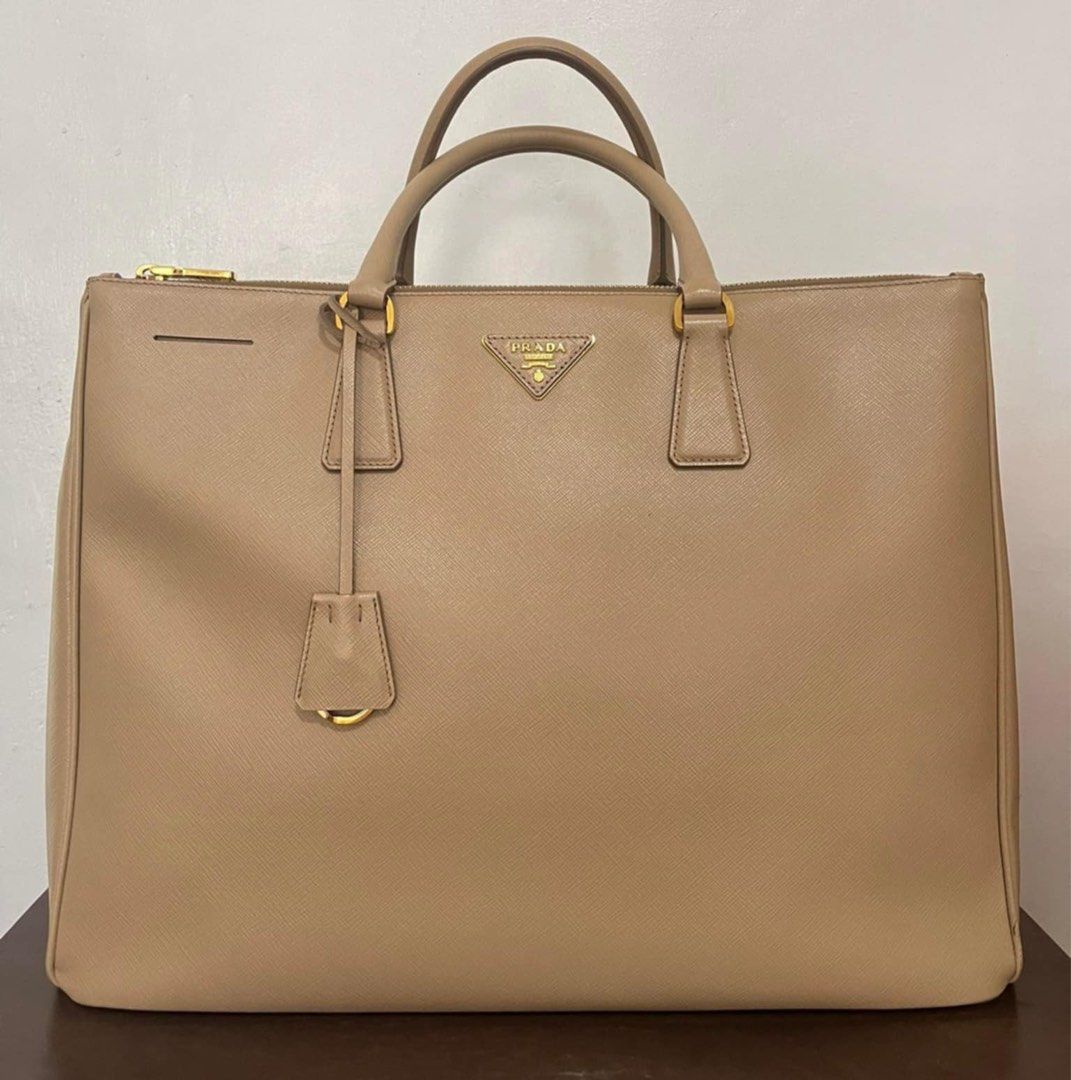 Prada Saffiano Lux Double Zip (Large) (Category: Luxury Bags & Wallets) located in Pasig City. Submitted by fl4ck0m7g_ (Listing ID 1358221177, Image 1). Description: Prado Saffiano Lux Double Zip Large Color: Sabbia Almost new pristine condition with free filler and handle wrap (c/o lovemybag.ph) with Authenticity card 50,000 only still negotiable.