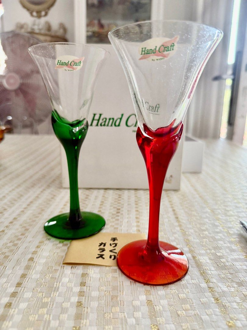 Wine glasses (Category: Other Kitchenware & Tableware) located in Mandaluyong City. Submitted by daisys.collection (Listing ID 1358433959, Image 2). Description: Pair of wine glasses with green and red stems. Made by Wing Japan Height = 7 in/ 12.5 cm Diameter = 3 in/ 7.5 cm Sold in pairs in a box Only 2 pairs available Can be used for Christmas dinners.