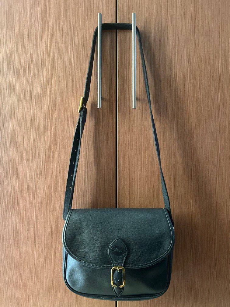 Longchamp Vintage Leather Sling Bag (Category: Luxury Bags & Wallets) located in Manila. Submitted by professionalwoman (Listing ID 1358566741, Image 1). Description: Original Longchamp Dark blue In very good condition Gold hardware Pure leather Negotiable ❤️.
