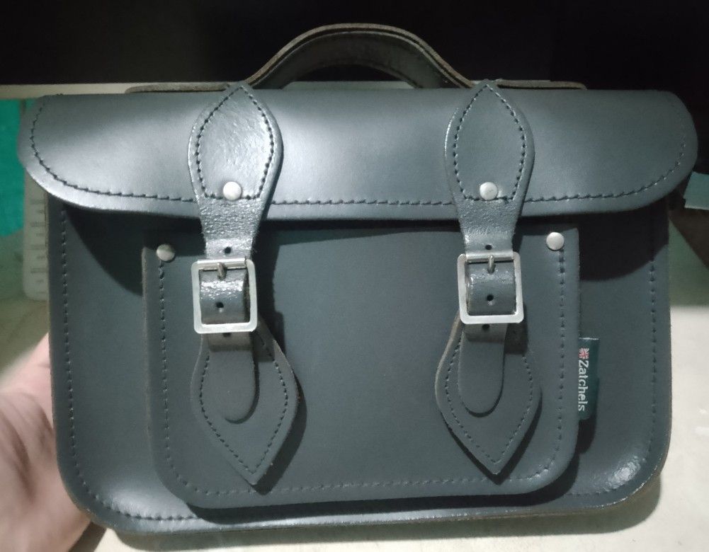 Genuine leather messenger bag (Category: Cross-body Bags) located in Makati City. Submitted by decluttering143 (Listing ID 1358866606, Image 1). Description: Genuine leather messenger bag top handle and detachable shoulder strap height 8 inches length 11.5 inch width 2.5 inch slightly used in good condition.