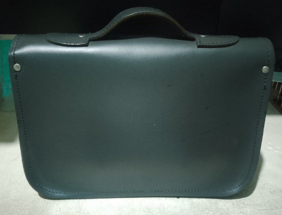 Genuine leather messenger bag (Category: Cross-body Bags) located in Makati City. Submitted by decluttering143 (Listing ID 1358866606, Image 2). Description: Genuine leather messenger bag top handle and detachable shoulder strap height 8 inches length 11.5 inch width 2.5 inch slightly used in good condition.