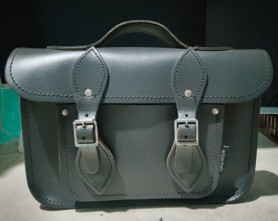 Genuine leather messenger bag (Category: Cross-body Bags) located in Makati City. Submitted by decluttering143 (Listing ID 1358866606, Image 3). Description: Genuine leather messenger bag top handle and detachable shoulder strap height 8 inches length 11.5 inch width 2.5 inch slightly used in good condition.