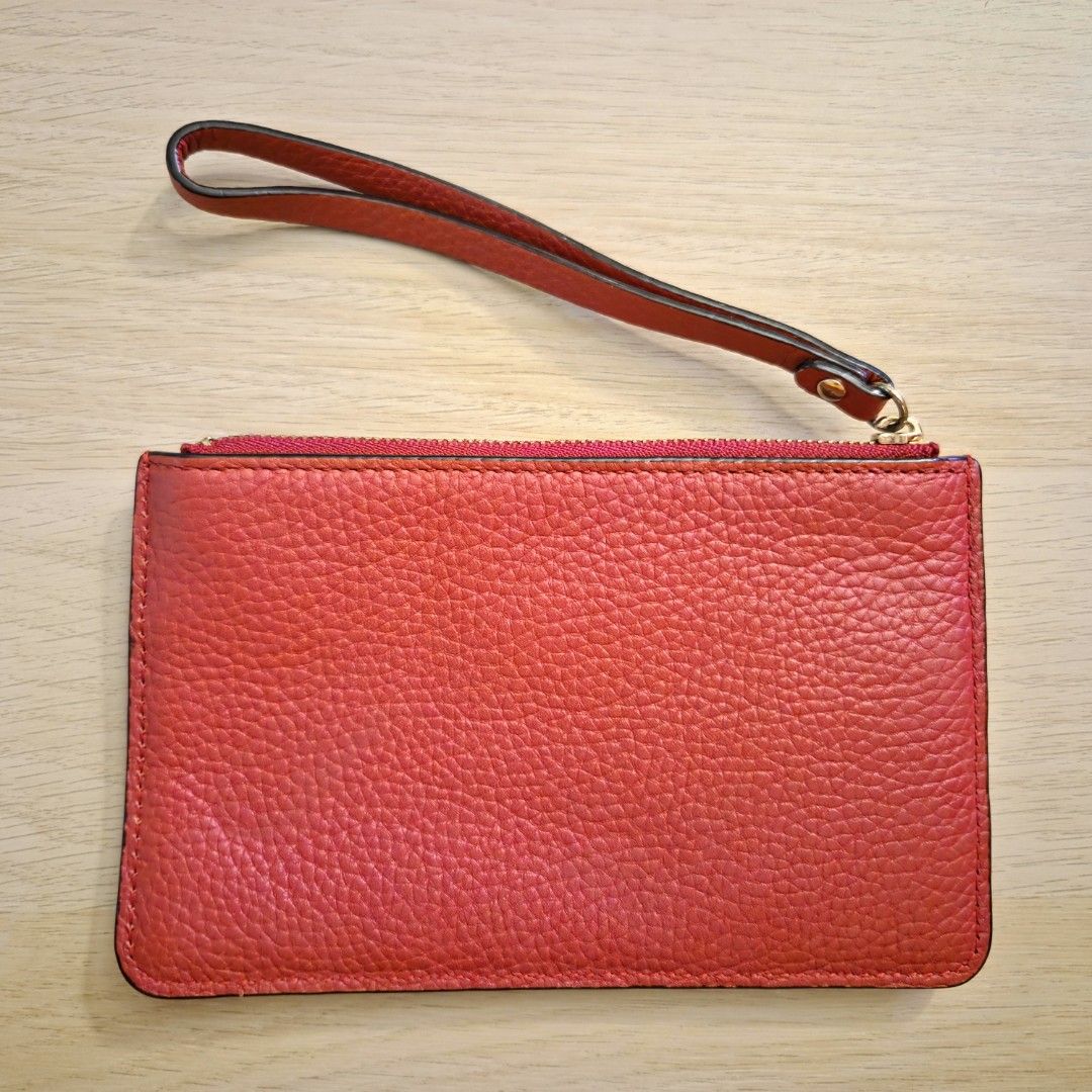 Kate Spade | Leather Wristlet Wallet (Red) (Category: Luxury Bags & Wallets) located in Quezon City. Submitted by m3262 (Listing ID 1358858185, Image 2). Description: • Unused; slightly old, but in good condition • Authentic; purchased from an official Kate Spade store in Hong Kong • No box included RFS: Decluttering Product details: • Dimensions: 6.5 x 4 inches • Pebble leather design • 1 main top zip compartment with wrist strap and 1 external 