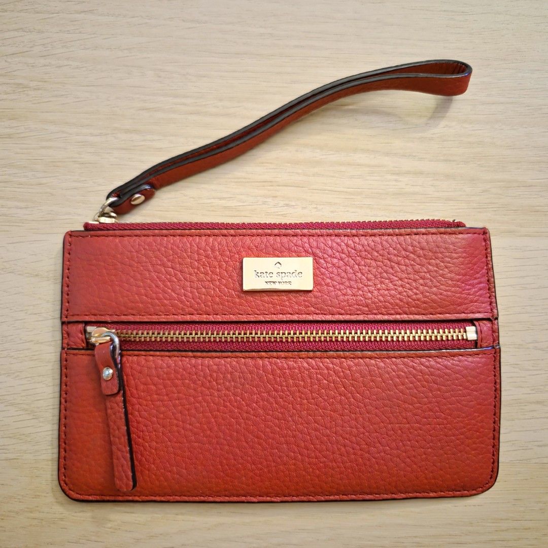 Kate Spade | Leather Wristlet Wallet (Red) (Category: Luxury Bags & Wallets) located in Quezon City. Submitted by m3262 (Listing ID 1358858185, Image 1). Description: • Unused; slightly old, but in good condition • Authentic; purchased from an official Kate Spade store in Hong Kong • No box included RFS: Decluttering Product details: • Dimensions: 6.5 x 4 inches • Pebble leather design • 1 main top zip compartment with wrist strap and 1 external 