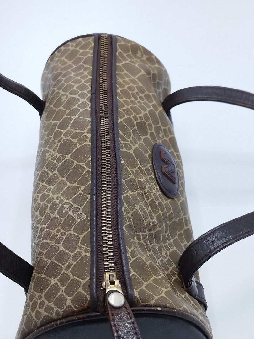 Nina Ricci Mini Barrel bag (Category: Luxury Bags & Wallets) located in Quezon City. Submitted by redragtag (Listing ID 1358747943, Image 3). Description: Authentic, vintage Nina Ricci bag in barrel shape Made in Italy Measurements: Height 10" x Length 5" Handle drop - 9.5" Description: - brown leather in pebbled prints and features the brand logo on the front - leather lining with open pocket - zip closure - 2 leather flat handles Condition: Ver