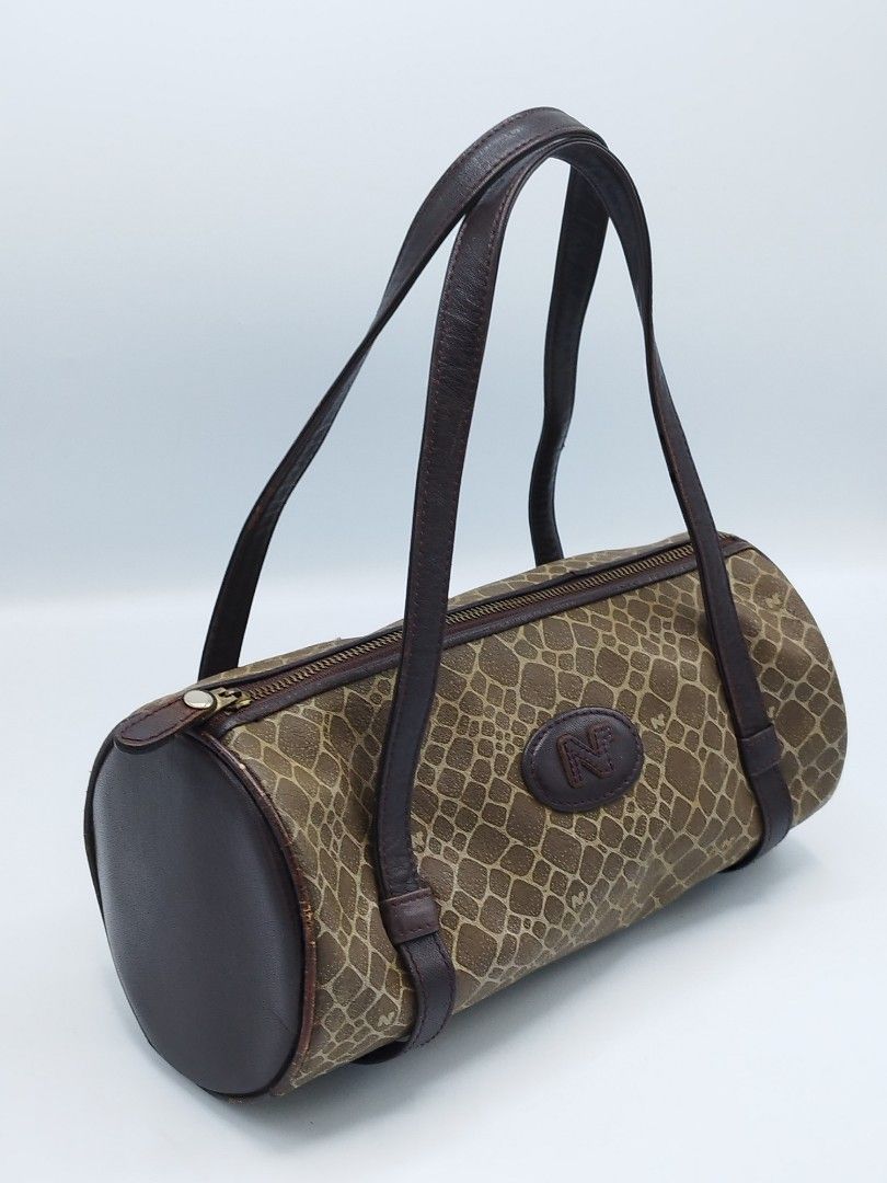 Nina Ricci Mini Barrel bag (Category: Luxury Bags & Wallets) located in Quezon City. Submitted by redragtag (Listing ID 1358747943, Image 2). Description: Authentic, vintage Nina Ricci bag in barrel shape Made in Italy Measurements: Height 10" x Length 5" Handle drop - 9.5" Description: - brown leather in pebbled prints and features the brand logo on the front - leather lining with open pocket - zip closure - 2 leather flat handles Condition: Ver