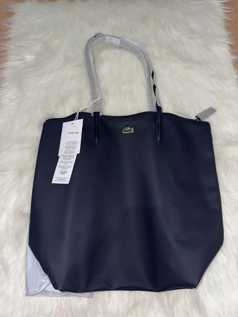 (AUTHENTIC) Lacoste Shoulder Bag in Navy Blue (Category: Luxury Bags & Wallets) located in Antipolo. Submitted by bhrl__48 (Listing ID 1359019407, Image 2). Description: - Bought originally for ₱5,895 - RFS: was supposed to gift to my sister but found a better color - COMES WITH PAPER BAG AND TAG - Dimensions: Length: 13 Height: 14.5 Width: 6.