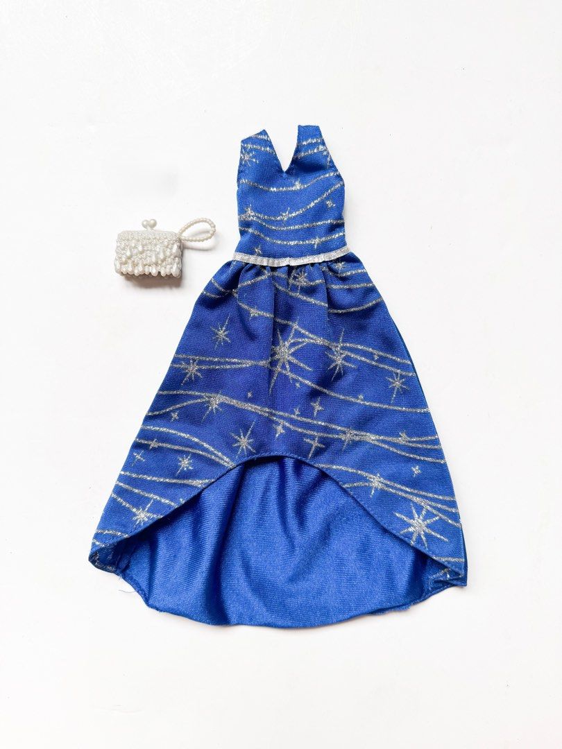 Barbie Complete Looks Navy Silver Sparkle Gown (Category: Evening dresses & gowns) located in Cainta. Submitted by mly_d (Listing ID 1358962575, Image 1). Description: Barbie Complete Looks Navy Silver Sparkle Gown ₱ 250 Inclusions: • The blue gown has a glittery print, sheer overlay on the bodice and a tapered hem. • A silvery clutch complete the look..