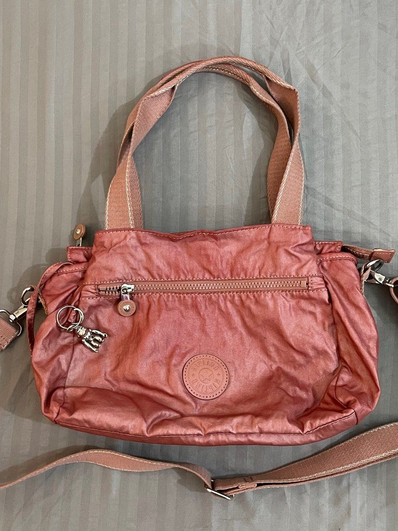 Kipling Elysia Shoulder Bag (Metallic Rust) (Category: Cross-body Bags) located in Manila. Submitted by eightch (Listing ID 1359114949, Image 3). Description: • 101% Authentic • Store bought • Original price: ₱6,300 • Tags discarded • Price negotiable - Product Details: Nylon, Polyurethane Coating Dimensions: 11.5” L x 9” H x 5” D Weight: 0.88 lbs Volume: 10L Adjustable, removable shoulder strap Dual carry handles Front zip pocket Back zip pocket