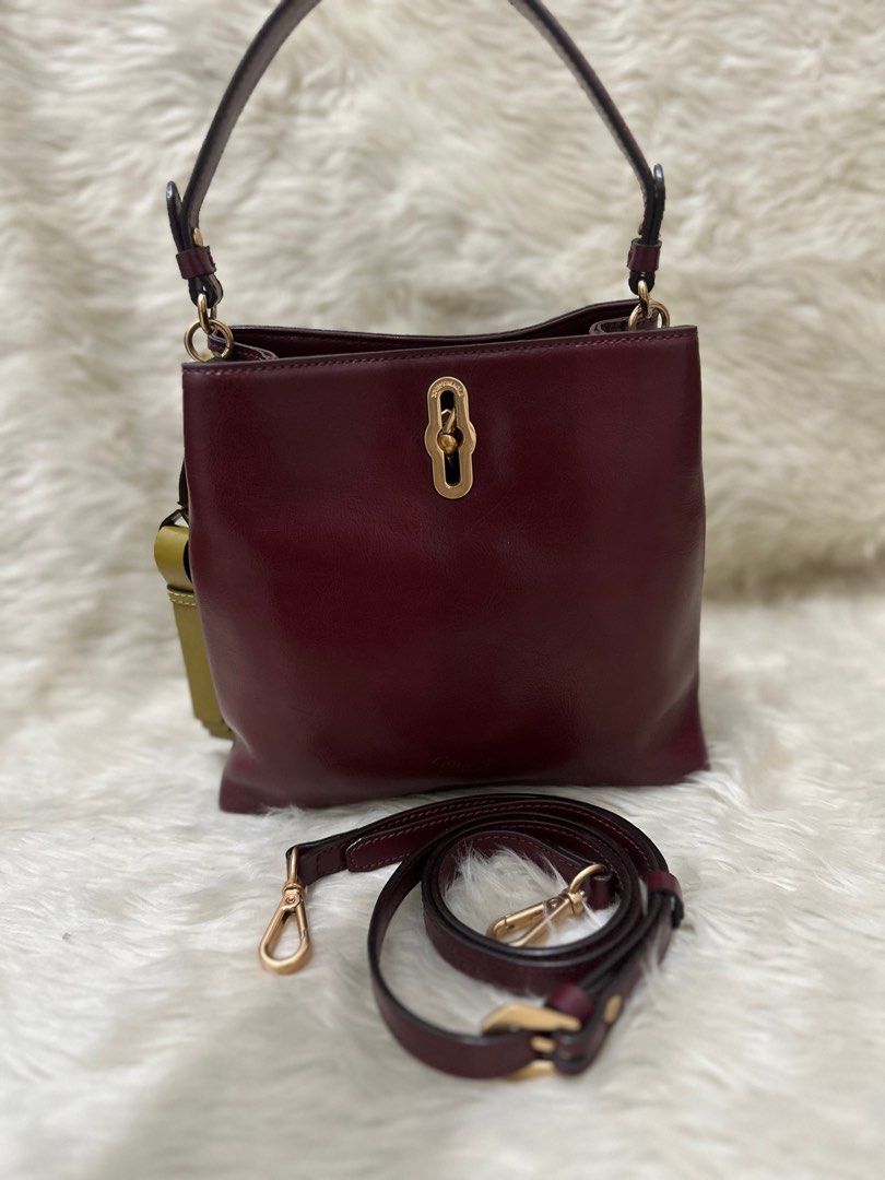 Maroon 2 Way Bag (Category: Cross-body Bags) located in Makati City. Submitted by petite_preloved2 (Listing ID 1358981924, Image 1). Description: High quality leather Very elegant color No tarnish on the hardware No fadings Clean interior with 2 compartments and is very spacious .