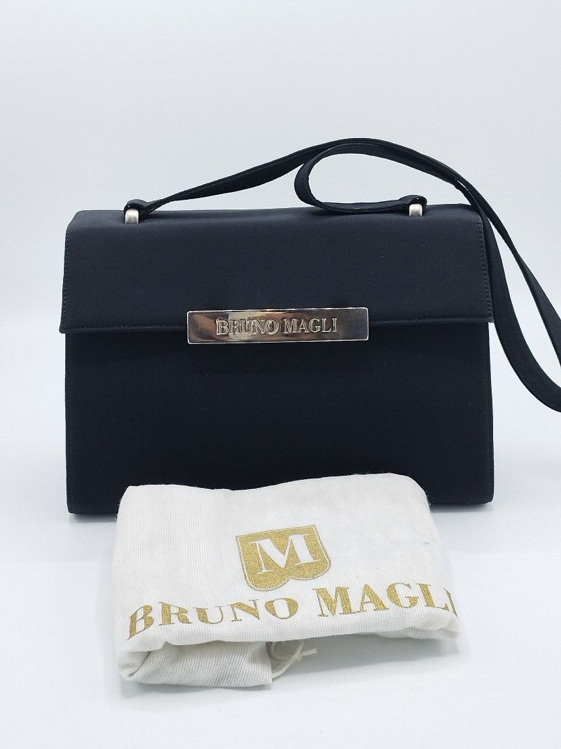 Bruno Magli Vintage Shoulder bag (Category: Luxury Bags & Wallets) located in Quezon City. Submitted by redragtag (Listing ID 1359142566, Image 1). Description: Authentic, vintage Bruno Magli shoulder bag Made in Italy Measurements: Height 7.75" x Length 11" x Depth 3" This bag features a flap with metal bar swing closure displaying the brand name " Bruno Magli". Characterized by black nylon-fabric exterior and a silver-toned hardware. Lined with