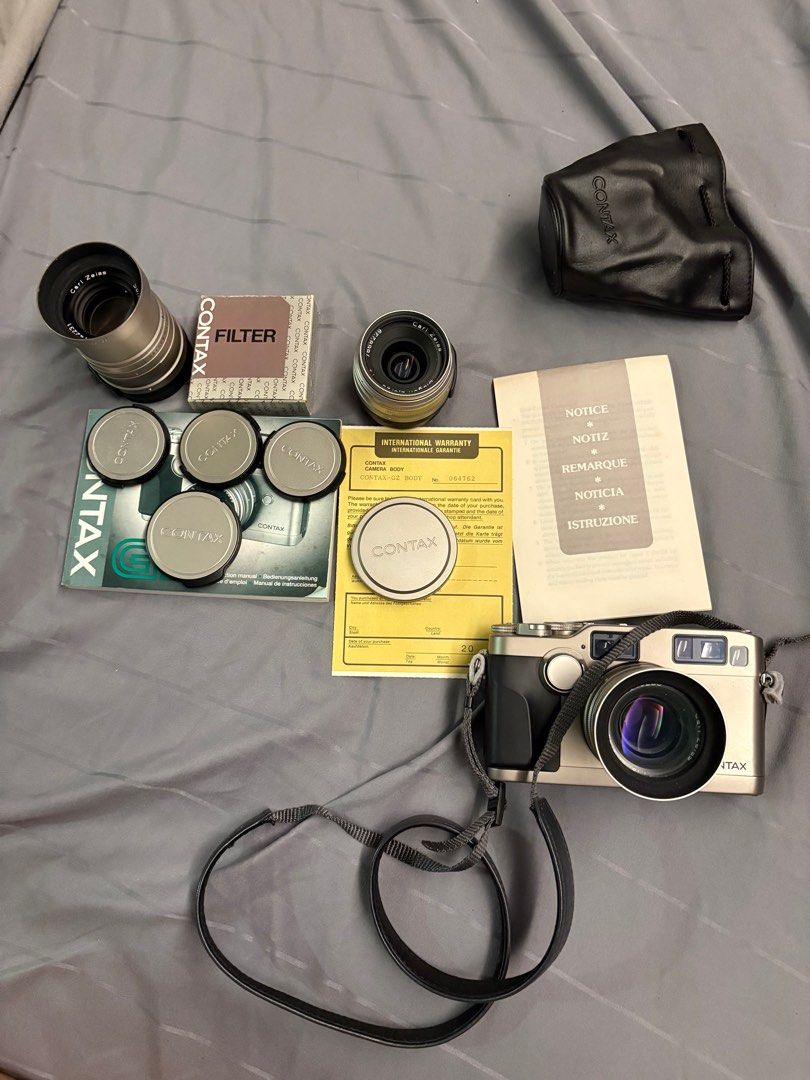 Contax G2 with 28, 45, and 90mm lenses (Category: Cameras) located in Singapore. Submitted by jmaxtan (Listing ID 1359229684, Image 1). Description: Near mint contax g2 set. Comes with 2 original matching contax filters for the 28 and 45mm. Also comes with 2 hoods .