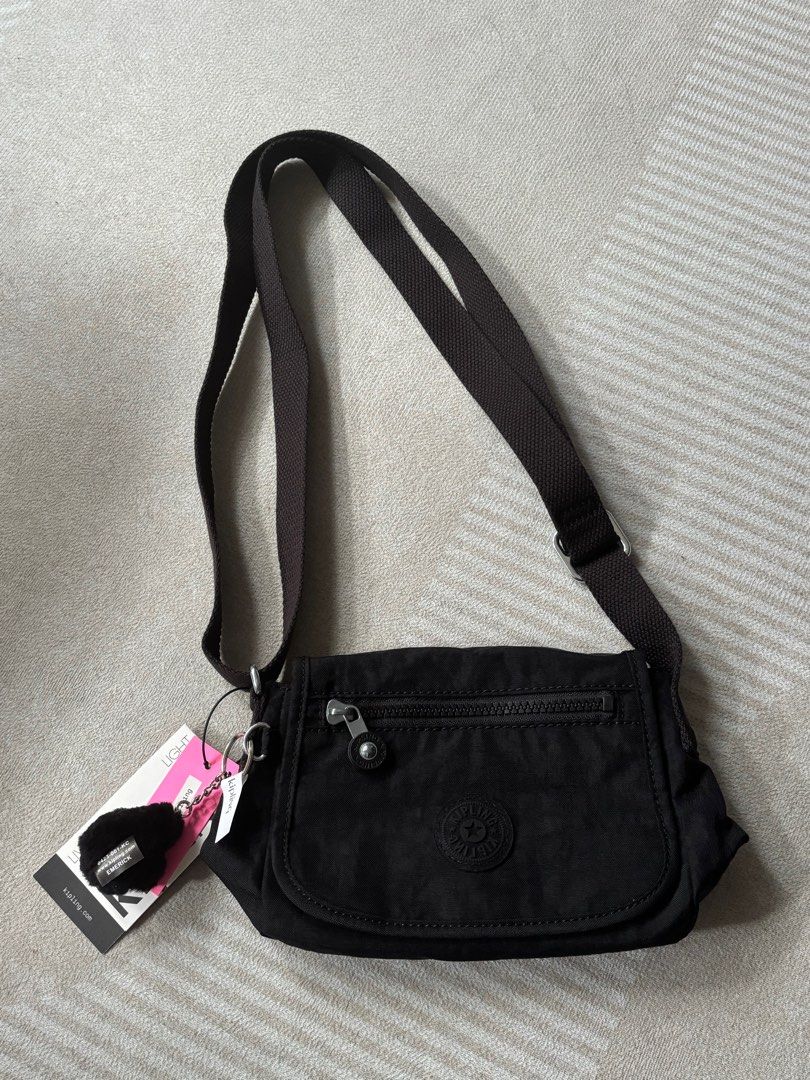 Kipling Black cross body bag (Category: Cross-body Bags) located in Taguig. Submitted by iamdanez (Listing ID 1359172755, Image 1). Description: Black Noir Sabian U Crossbody bag Exterior: Nylon / Interior: Recycled Polyester Dimensions: 7.75’’L x 5.75’’H x 3.25’’D Weight: 0.38 lbs Volume: 2L Adjustable strap Front zip pocket Flap closure with magnetic snap Internal zip pocket Monkey keychain Shortest strap length: 27.5” Extended strap length: 53