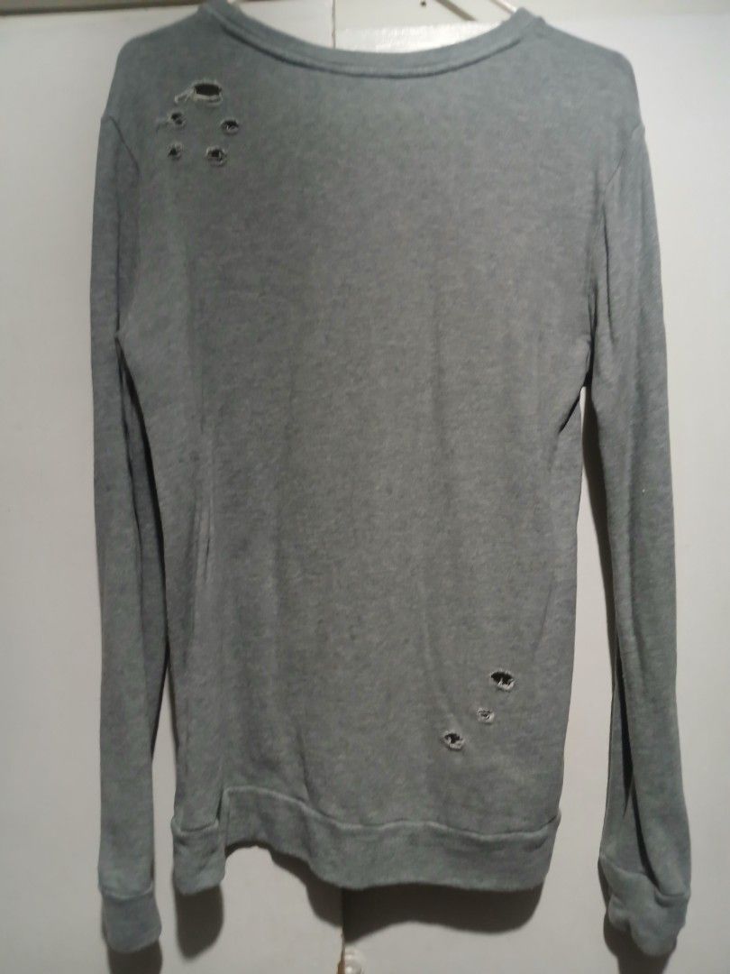 Pre Loved- Penshoppe- Gray Hole Design Sweatshirt- Medium Size (Category: Coats, Jackets and Outerwear) located in Quezon City. Submitted by mimil_ (Listing ID 1359269018, Image 2). Description: Penshoppe Gray sweatshirt with hole deisgn Can fit from small to medium size Used it twice or thrice.