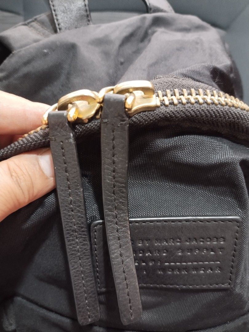 marc jacobs backpack (Category: Luxury Bags & Wallets) located in Baguio. Submitted by roozeydluc (Listing ID 1356014638, Image 3). Description: polyester material large size l:12.5" w:5" h:16.5" 🔎mga small bubbles sa side part ✓1 zippered compartment ✓2 zippered front pocket.