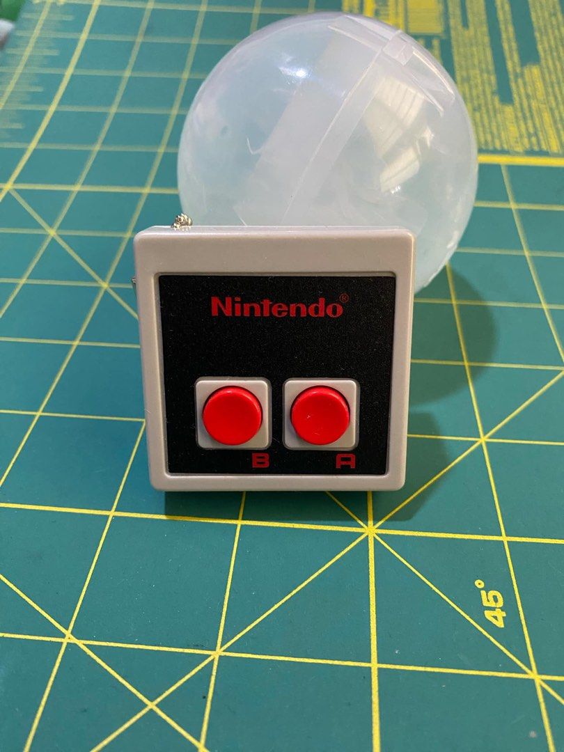 Nintendo Japan NES Controller Keychain (Category: Controllers) located in Manila. Submitted by numbstar (Listing ID 1355899839, Image 2). Description: Brand new, sealed and authentic Nintendo Japan NES Controller Keychain Photo 1 is actual photo of sealed item Photo 2 is what item looks like when opened (took this photo from my personal collection to show what item will look like when opened).