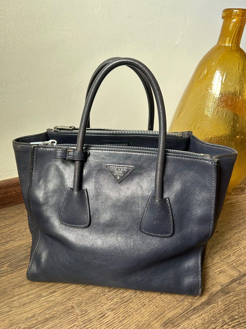 Prada Tote - Vintage from Japan (Category: Bags & Wallets) located in Singapore. Submitted by rowanmama (Listing ID 1355851034, Image 1). Description: The bag with still with Prada Triangle Logo, rare piece No dustbag, no card, just the bag From Japan #totebag #laptopbag #navyblue #vintage Not for fussies .