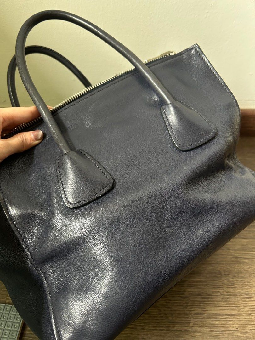 Prada Tote - Vintage from Japan (Category: Bags & Wallets) located in Singapore. Submitted by rowanmama (Listing ID 1355851034, Image 2). Description: The bag with still with Prada Triangle Logo, rare piece No dustbag, no card, just the bag From Japan #totebag #laptopbag #navyblue #vintage Not for fussies .