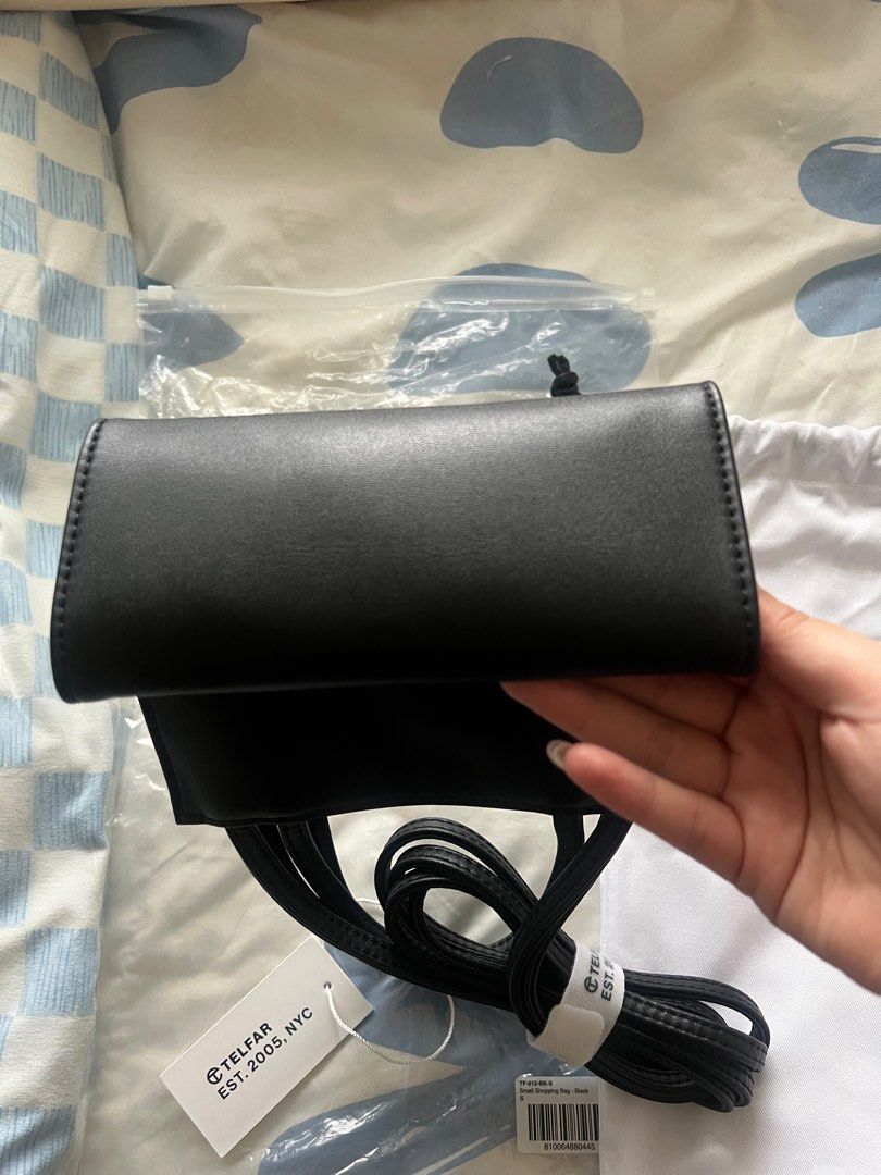 Telfar Small Shopping Bag in Black (Category: Luxury Bags & Wallets) located in Pasig City. Submitted by kurtlorraine (Listing ID 1350663580, Image 2). Description: Telfar Small Shopping Bag in Black - Comes with original plastic, tags, & dust bag - Used in my Japan trip only - 100% Authentic bought in States - No flaws, scratchs - Can pass as brand new .