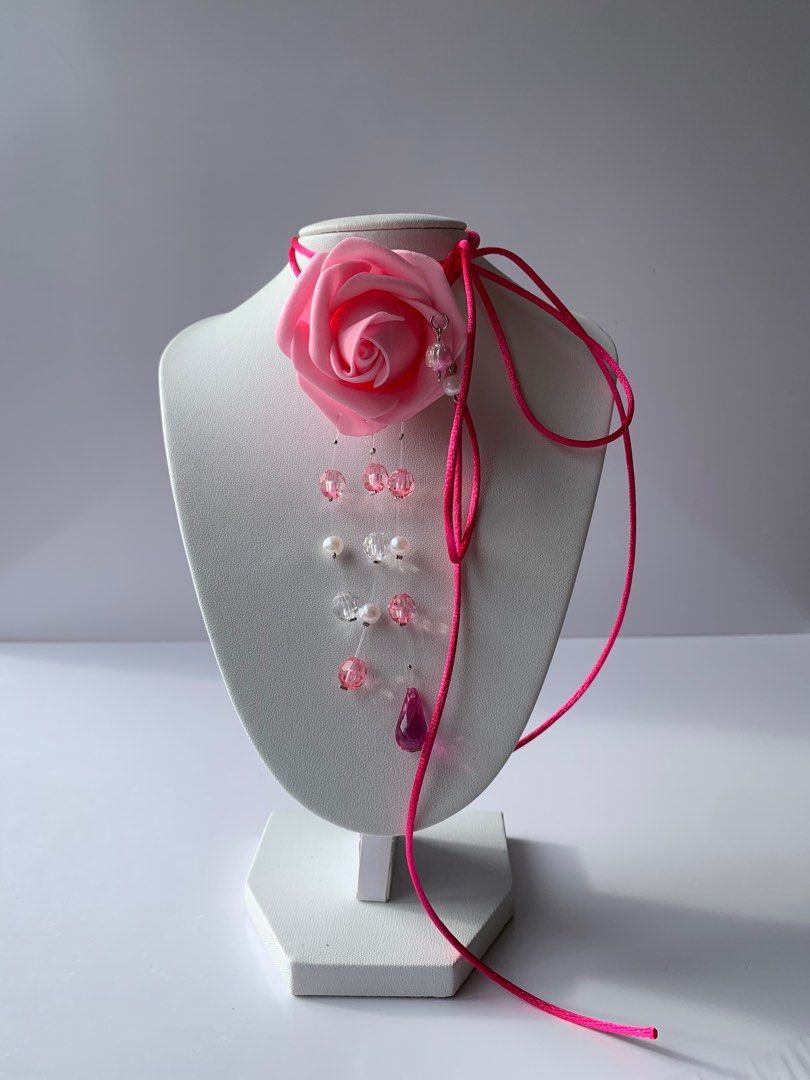SAINTY Pink Rose Cord Necklace (Category: Necklaces) located in Marikina City. Submitted by aimamor (Listing ID 1359441385, Image 1). Description: Pink Rose Cord Necklace | Perfect for Summer All handmade and carefully assembled 🤲🏻 • Rubber Flower Rose • Beautiful bead drops Orchid Size: • Cord: 51”.