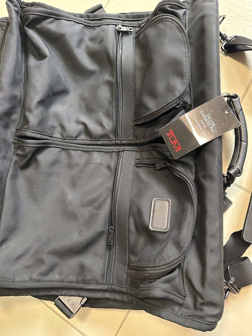 Tumi Alpha bi fold ballistic garment bag (Category: Luxury Bags & Wallets) located in Paranaque City. Submitted by tigerbomb (Listing ID 1359321564, Image 2). Description: Brand new bought in US Exterior Features: -Two U-zip pockets -Flat zip pockets -Back zip pocket -Top and bottom carry handles -Add-a-Bag sleeve -Removable shoulder strap Interior Features: -Garment curtain with zip pockets -Removable laundry bag -Shoulder pockets -Garment exten