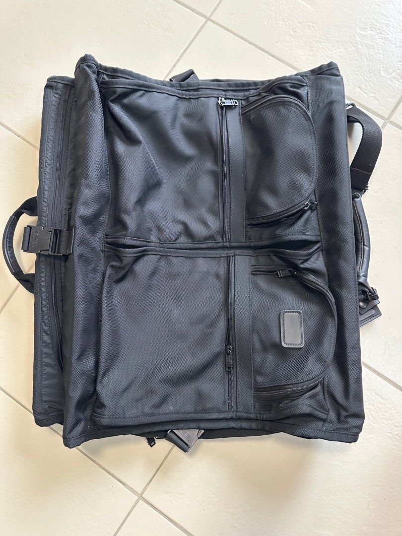 Tumi Alpha bi fold ballistic garment bag (Category: Luxury Bags & Wallets) located in Paranaque City. Submitted by tigerbomb (Listing ID 1359321564, Image 1). Description: Brand new bought in US Exterior Features: -Two U-zip pockets -Flat zip pockets -Back zip pocket -Top and bottom carry handles -Add-a-Bag sleeve -Removable shoulder strap Interior Features: -Garment curtain with zip pockets -Removable laundry bag -Shoulder pockets -Garment exten