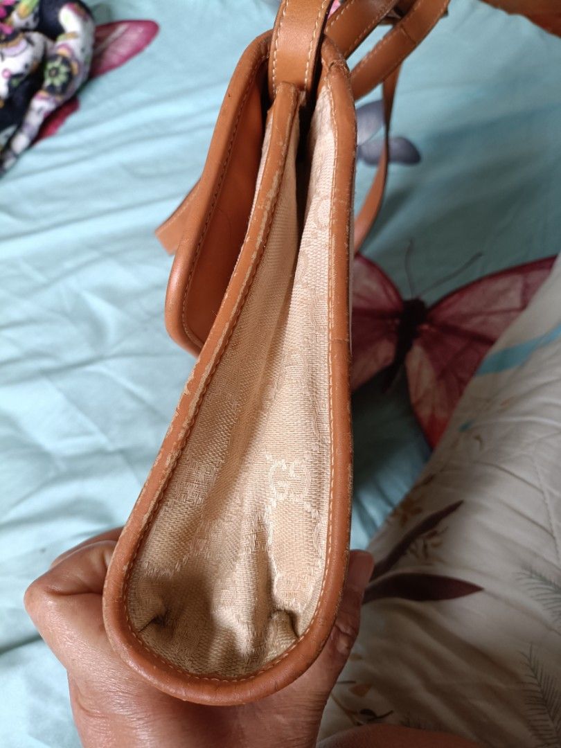 Vintage Gucci bag 1980's (Category: Luxury Bags & Wallets) located in Cainta. Submitted by prelovedbags06 (Listing ID 1359492985, Image 3). Description: GG coated canvas Leather crossbody/ shoulder bag gold hardware adjustable strap gold knight metal charm bag NOTE: need recolor since vintage bag expect discoloration in lining see pictures pm for more details.