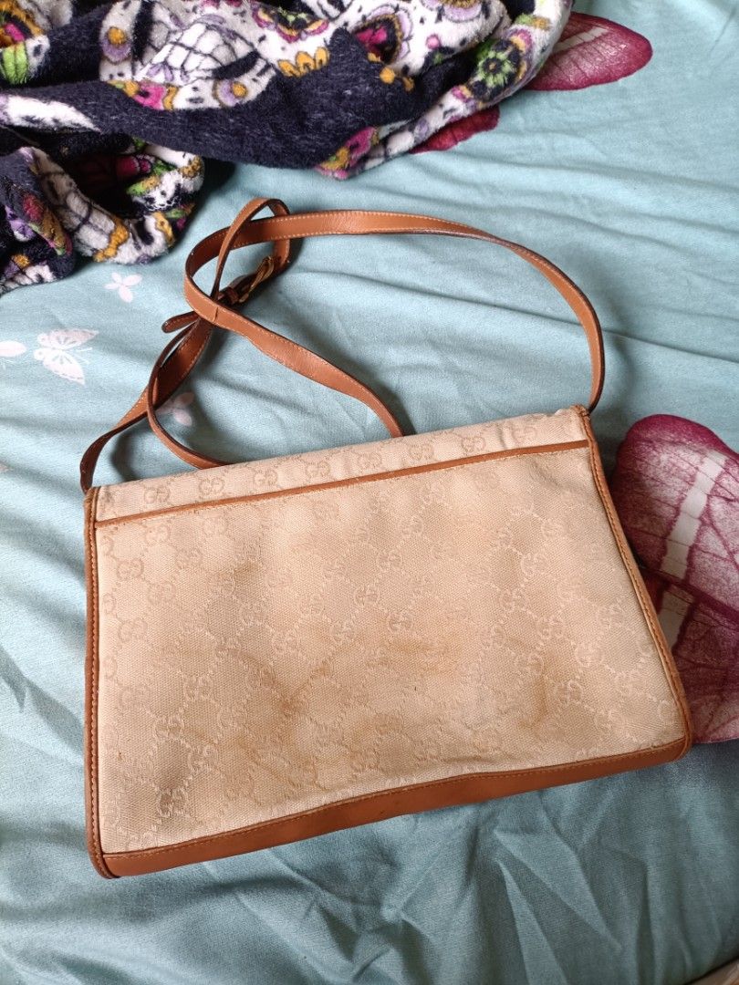 Vintage Gucci bag 1980's (Category: Luxury Bags & Wallets) located in Cainta. Submitted by prelovedbags06 (Listing ID 1359492985, Image 2). Description: GG coated canvas Leather crossbody/ shoulder bag gold hardware adjustable strap gold knight metal charm bag NOTE: need recolor since vintage bag expect discoloration in lining see pictures pm for more details.