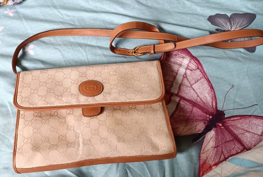 Vintage Gucci bag 1980's (Category: Luxury Bags & Wallets) located in Cainta. Submitted by prelovedbags06 (Listing ID 1359492985, Image 1). Description: GG coated canvas Leather crossbody/ shoulder bag gold hardware adjustable strap gold knight metal charm bag NOTE: need recolor since vintage bag expect discoloration in lining see pictures pm for more details.