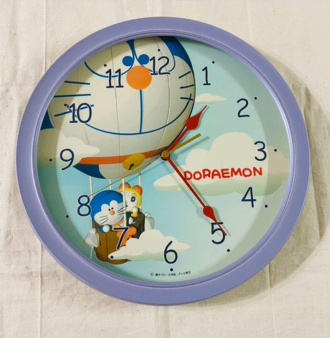 Doraemon Wall Clock (Category: Clocks) located in Bulacan. Submitted by ourdailyfinds (Listing ID 1359697744, Image 1). Description: ✨ Doraemon Timepiece Magic! ⏰💙 ✨ Add a touch of nostalgia and fun to your space with this adorable Doraemon Wall Clock! Featuring your favorite robotic cat soaring in a hot air balloon, this clock is a whimsical blend of function and charm. 🕰 Features: ✔️ Vibrant Doraemon design 🎈 ✔️ Easy-to-read numbers 📅 ✔️ Pe