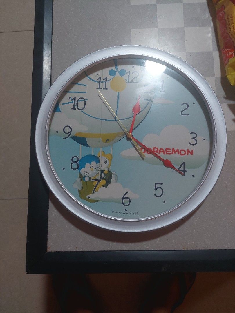 Doraemon Wall Clock (Category: Clocks) located in Bulacan. Submitted by ourdailyfinds (Listing ID 1359697744, Image 3). Description: ✨ Doraemon Timepiece Magic! ⏰💙 ✨ Add a touch of nostalgia and fun to your space with this adorable Doraemon Wall Clock! Featuring your favorite robotic cat soaring in a hot air balloon, this clock is a whimsical blend of function and charm. 🕰 Features: ✔️ Vibrant Doraemon design 🎈 ✔️ Easy-to-read numbers 📅 ✔️ Pe