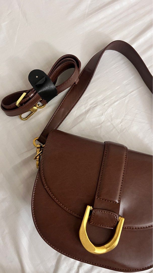 Charles and Keith Gabine Saddle Bag (Category: Cross-body Bags) located in Quezon City. Submitted by col.funshot (Listing ID 1359957117, Image 3). Description: Mall pullout item as claimed, bought from ig shop Medium size Brown color for that old money, casual everyday use Shoulder strap and crossbody strap Rfs: Rarely used Shipping fee c/o buyer No returns. Don’t transact if not sure.