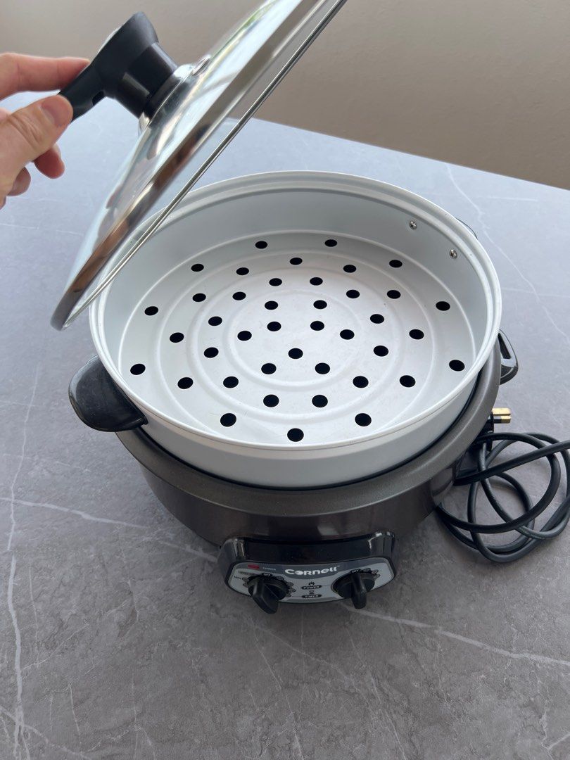 Cornell Multi-function Cooker (Category: Cookers) located in Singapore. Submitted by 24wheels (Listing ID 1359873838, Image 2). Description: This is a Cornell multi-function cooker that is 2 years old. It is in very good condition and works well. It can be used for steamboat steaming, cooking soup, and many other functions. It comes with a glass lid and a steamer basket..
