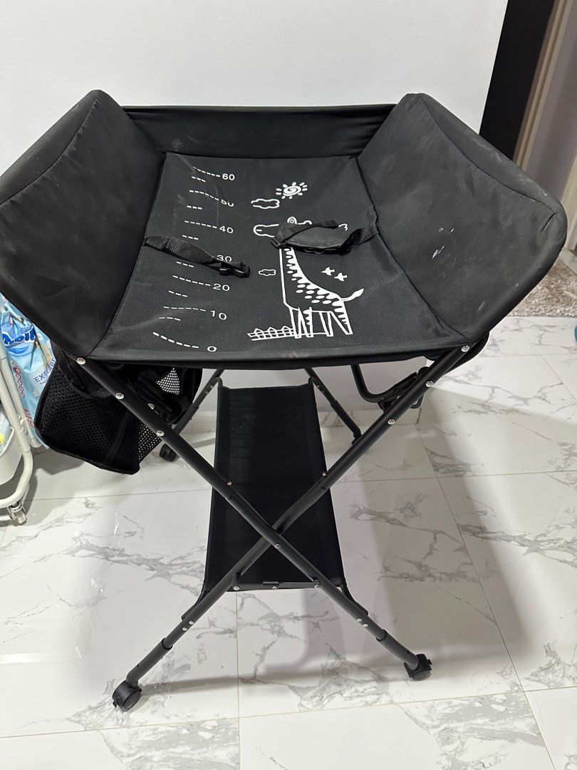 Foldable Changing Table (Category: Changing Mats & Accessories) located in Singapore. Submitted by nataetae (Listing ID 1359855086, Image 3). Description: Foldable changing table with hanging bar for towels and storage baskets..