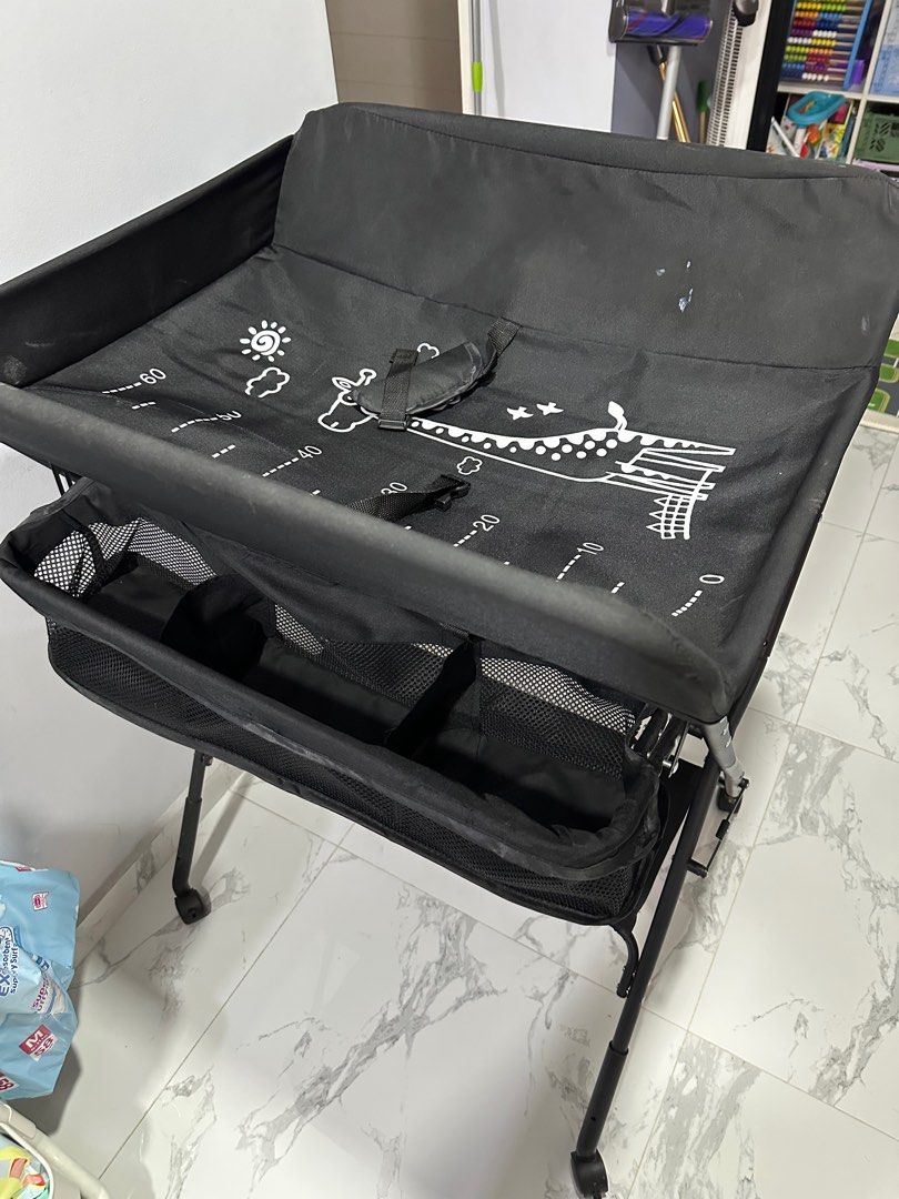 Foldable Changing Table (Category: Changing Mats & Accessories) located in Singapore. Submitted by nataetae (Listing ID 1359855086, Image 2). Description: Foldable changing table with hanging bar for towels and storage baskets..