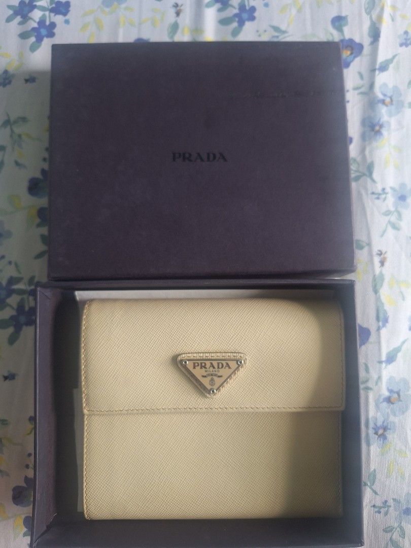 Prada Bifold Wallet (Category: Luxury Bags & Wallets) located in Quezon City. Submitted by tms.l (Listing ID 1359923814, Image 1). Description: COLOR: BONE COMES WITH ORIGINAL BOX NEEDS CLEANING BUT OTHERWISE IN EXCELLENT CONDITION.