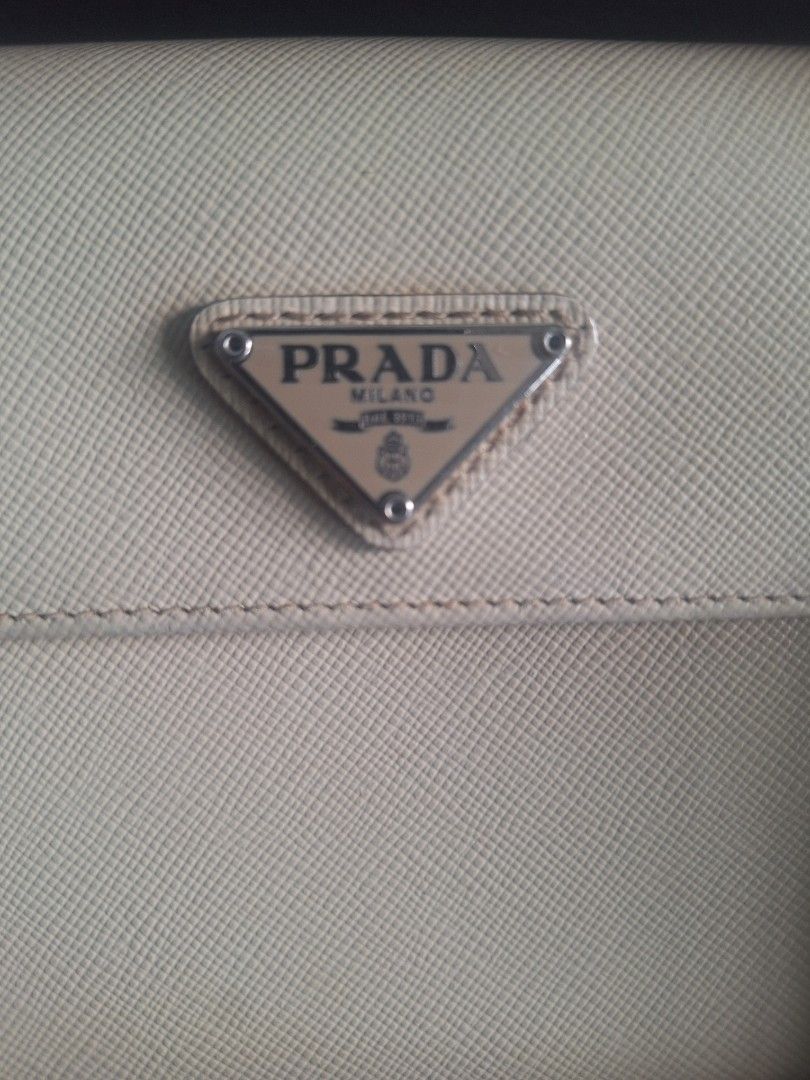 Prada Bifold Wallet (Category: Luxury Bags & Wallets) located in Quezon City. Submitted by tms.l (Listing ID 1359923814, Image 2). Description: COLOR: BONE COMES WITH ORIGINAL BOX NEEDS CLEANING BUT OTHERWISE IN EXCELLENT CONDITION.