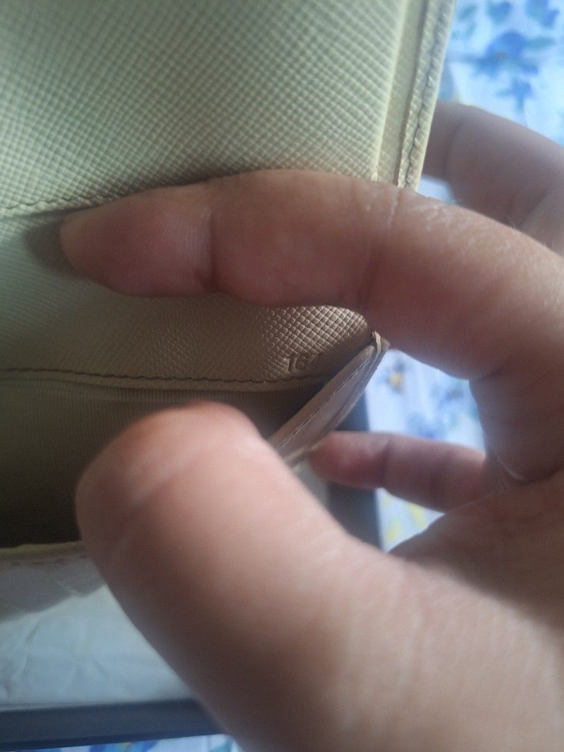 Prada Bifold Wallet (Category: Luxury Bags & Wallets) located in Quezon City. Submitted by tms.l (Listing ID 1359923814, Image 3). Description: COLOR: BONE COMES WITH ORIGINAL BOX NEEDS CLEANING BUT OTHERWISE IN EXCELLENT CONDITION.