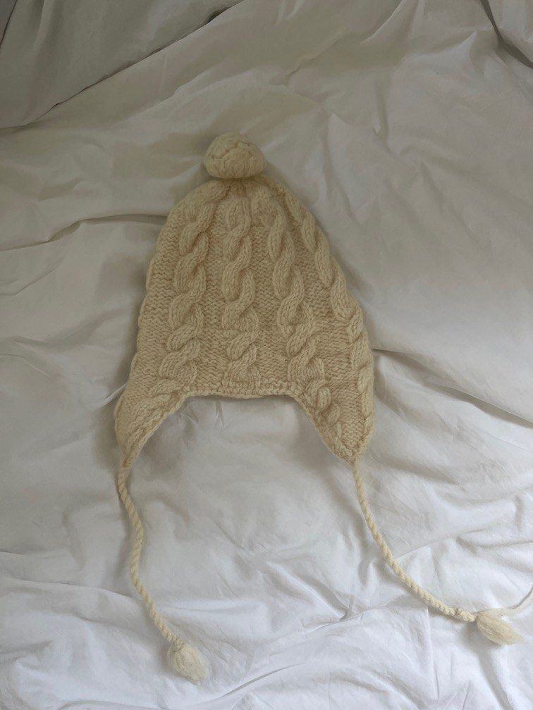 White 100% Wool Knitted Hat/Beanie (from Nepal) (Category: Hats & Beanies) located in Manila. Submitted by sofiaalte (Listing ID 1359871706, Image 1). Description: Made in Nepal 100% Wool. Really warm with cute strings. For small heads! .
