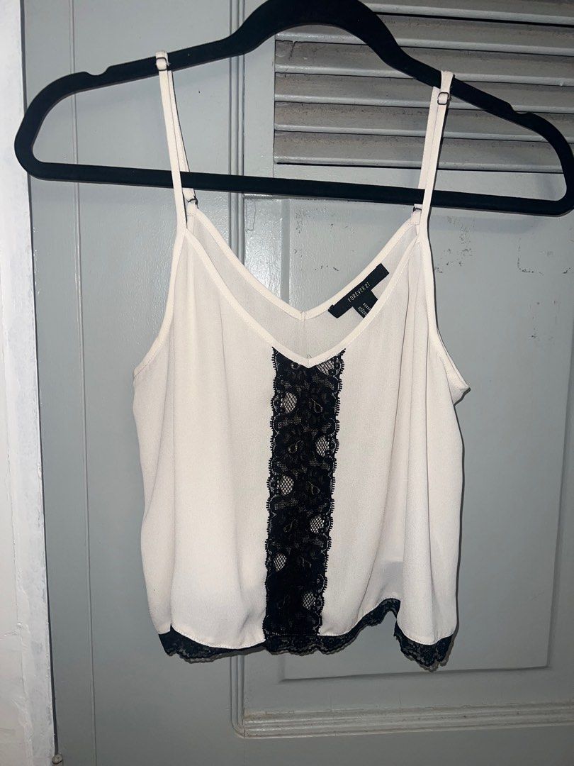 Forever21 Cropped Black & White Lace Top (Category: Sleeveless) located in Pasig City. Submitted by lbclosetcleanup (Listing ID 1360237180, Image 1). Description: Adjustable straps.