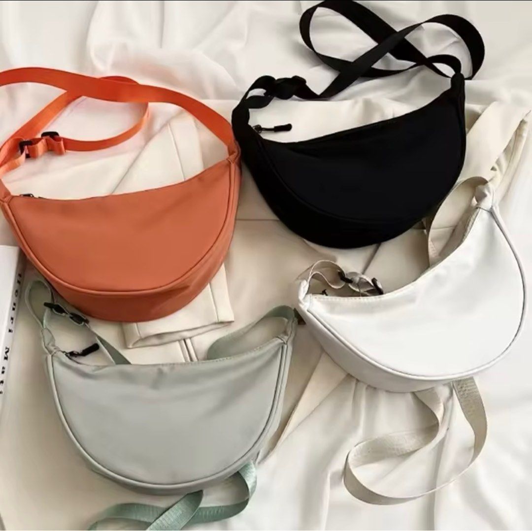 Women Shoulder Bags Solid Color Nylon Dumpling Messenger Bag (Category: Shoulder Bags) located in Paranaque City. Submitted by michelleko02 (Listing ID 1360283202, Image 3). Description: Material: nylon Size: top width 30cm, bottom width 18cm, height 16cm, thickness 9.5cm Color: white, black, green, orange #makethebest1 #sideline2 #savings3 #treasure4.