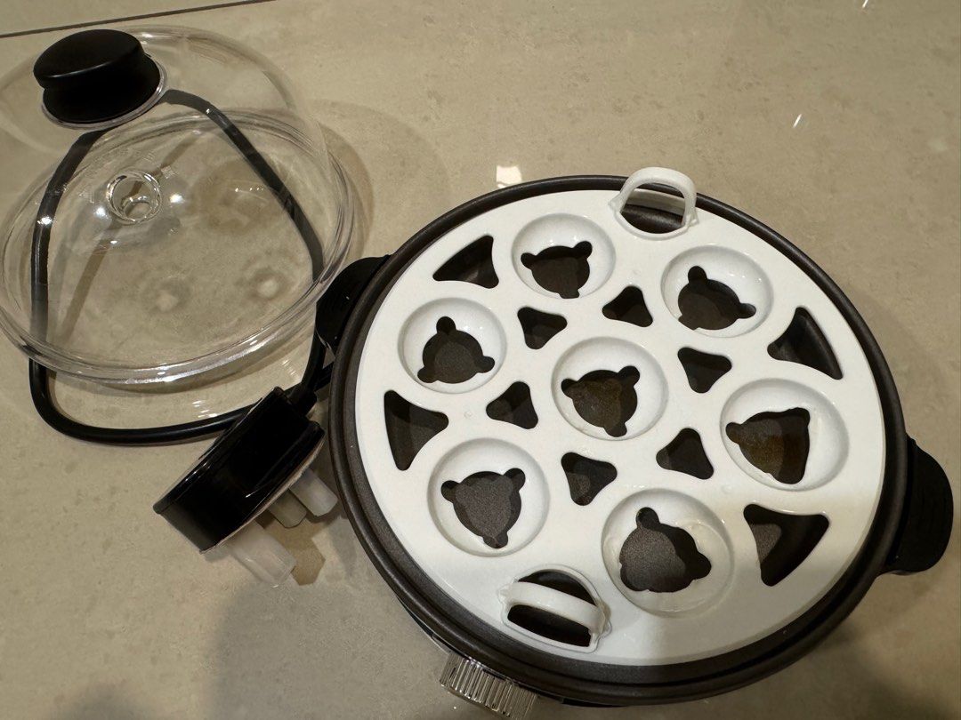 Egg maker (Category: Other Kitchen Appliances) located in Puchong. Submitted by preloved_chance (Listing ID 1360522816, Image 3). Description: Can make soft or hard boiled eggs with timer. Comes with water measurement cup. Egg holder slightly melted due to high heat but overall still good condition..