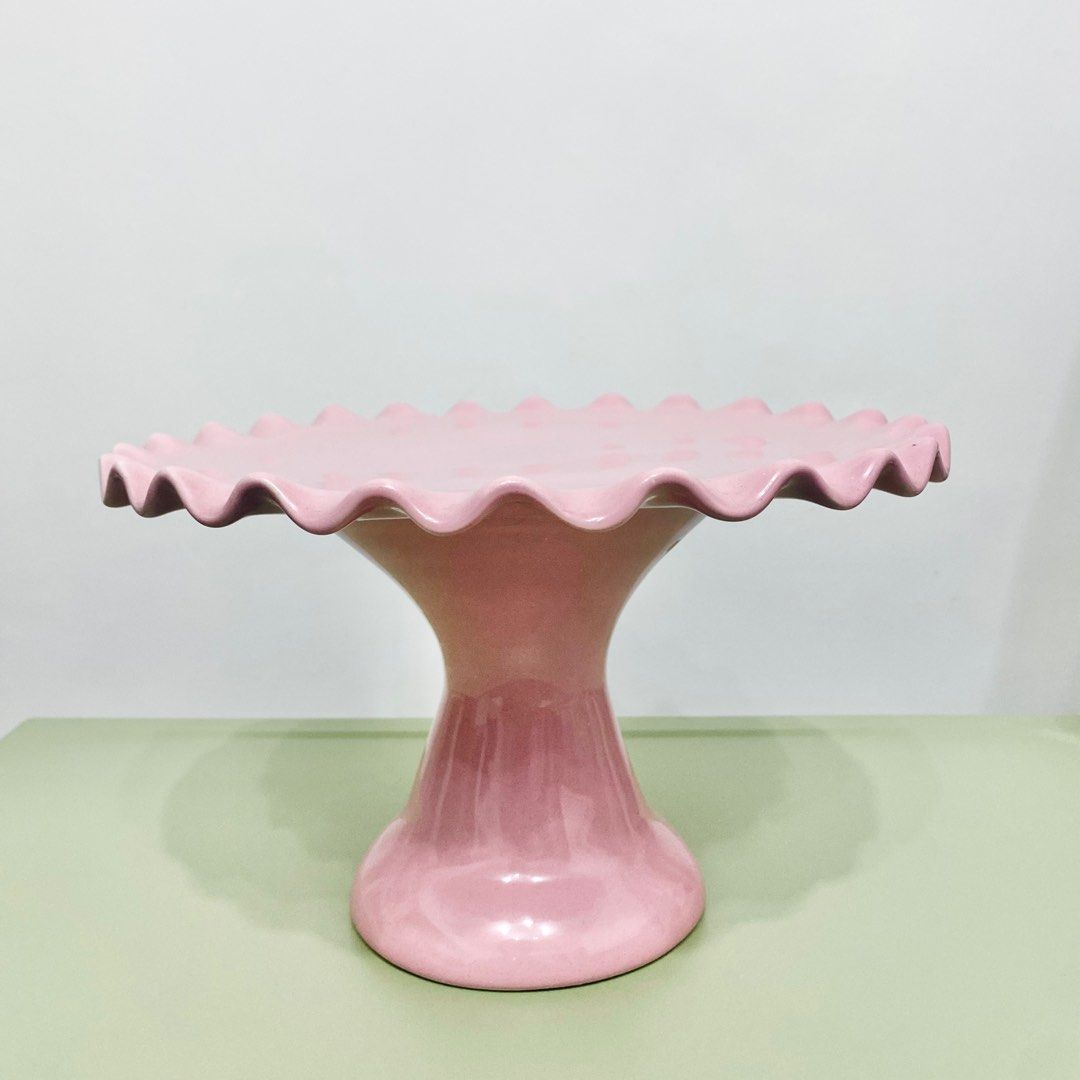Pink Cake Stand (Category: Other Kitchenware & Tableware) located in Makati City. Submitted by aideclutter (Listing ID 1360557782, Image 2). Description: • Never Used • Material : Ceramic • Size : 10 inches (diameter) • Can fit 8-9 inch cake • Can also be used to hold cookies, cupcakes, donuts, & other pastries • Buyer shoulders DF • RFS : Decluttering • Discoloration on some parts have been present since it was bought. • Metro Manila delivery on