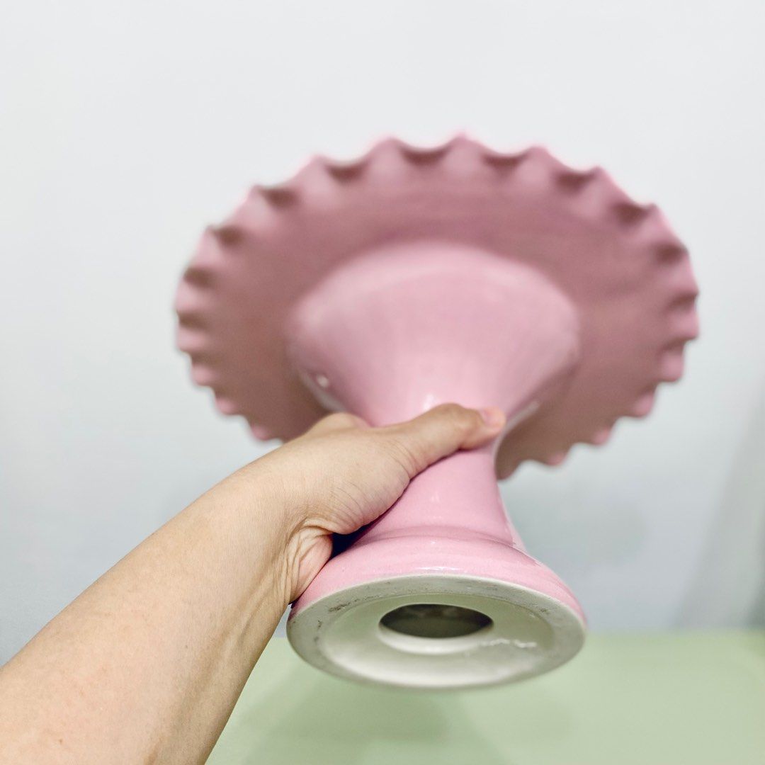 Pink Cake Stand (Category: Other Kitchenware & Tableware) located in Makati City. Submitted by aideclutter (Listing ID 1360557782, Image 3). Description: • Never Used • Material : Ceramic • Size : 10 inches (diameter) • Can fit 8-9 inch cake • Can also be used to hold cookies, cupcakes, donuts, & other pastries • Buyer shoulders DF • RFS : Decluttering • Discoloration on some parts have been present since it was bought. • Metro Manila delivery on