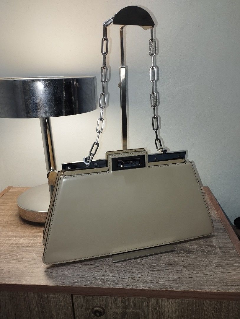 Fendi Peekaboo cut (Category: Luxury Bags & Wallets) located in Rizal. Submitted by shoppin_craze (Listing ID 1360712727, Image 1). Description: silver chain strap, comes with dustbag. medium sized. can be worn as shoulder bag or clutch. beige gray in color. very good condition free delivery via j&t courier. no COD.